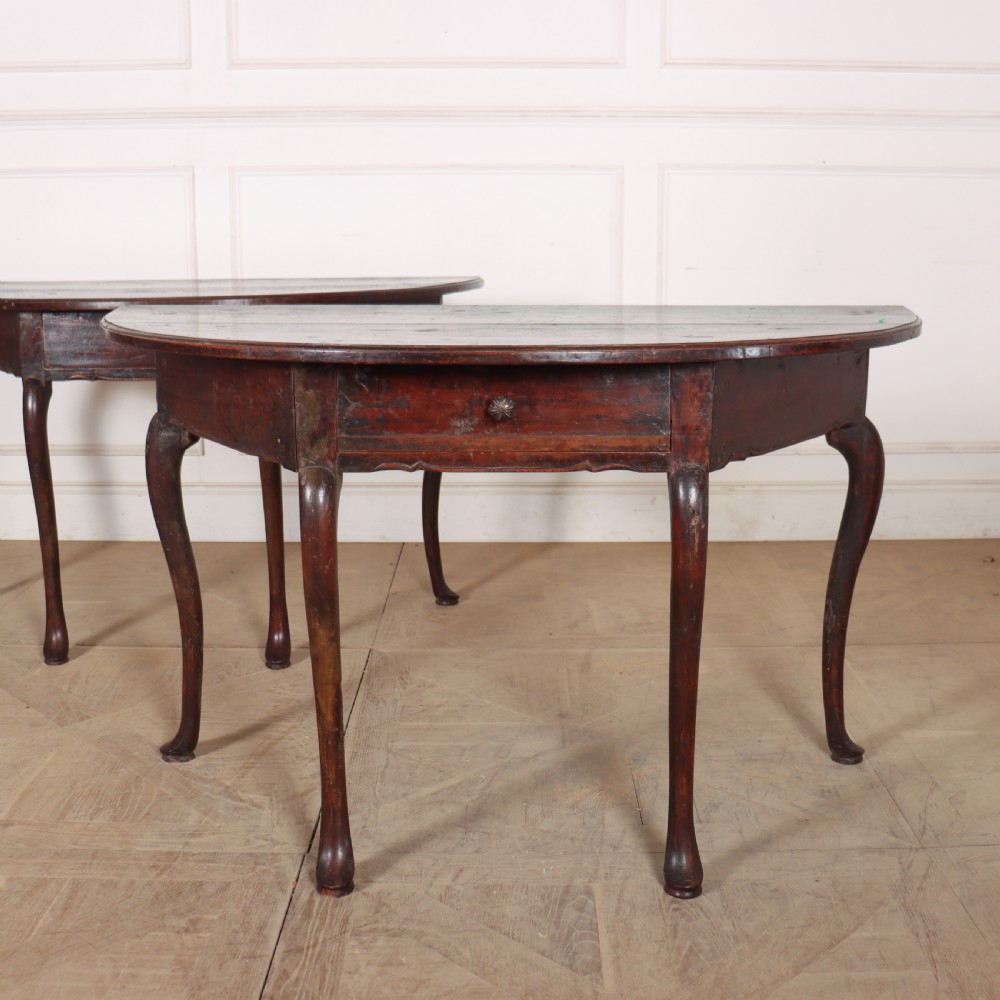 A pair of dark wood demi-lune console tables featuring semi-circular tops, single frieze drawers, and slender cabriole legs. View II