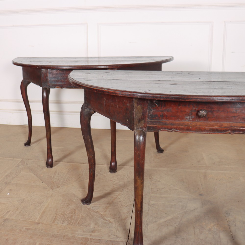 A pair of dark wood demi-lune console tables featuring semi-circular tops, single frieze drawers, and slender cabriole legs. View IV