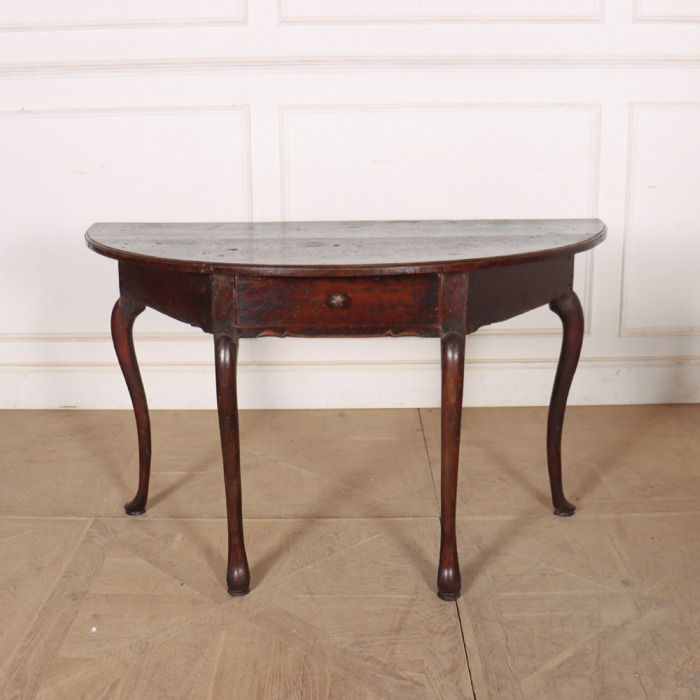 A pair of dark wood demi-lune console tables featuring semi-circular tops, single frieze drawers, and slender cabriole legs. View VI