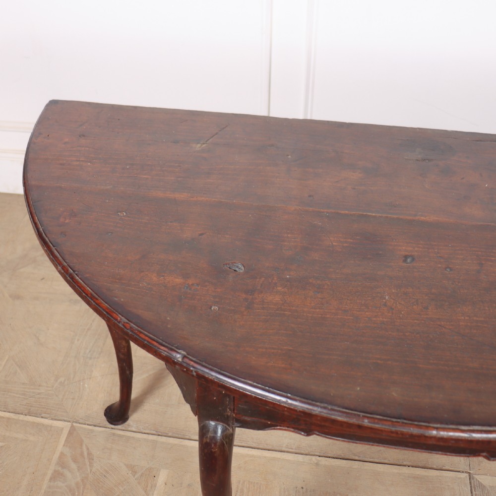 A pair of dark wood demi-lune console tables featuring semi-circular tops, single frieze drawers, and slender cabriole legs. View VIII