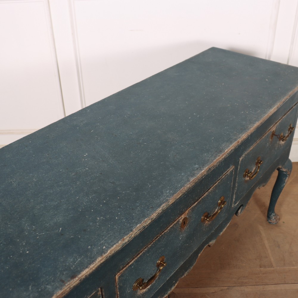 An antique blue-painted dresser base featuring three drawers with brass drop handles, a scalloped apron, and cabriole legs. View XII