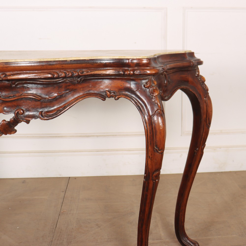 An antique 1920s Italian console table featuring a serpentine front, carved apron with scroll detailing, cabriole legs, and a marble top. View V