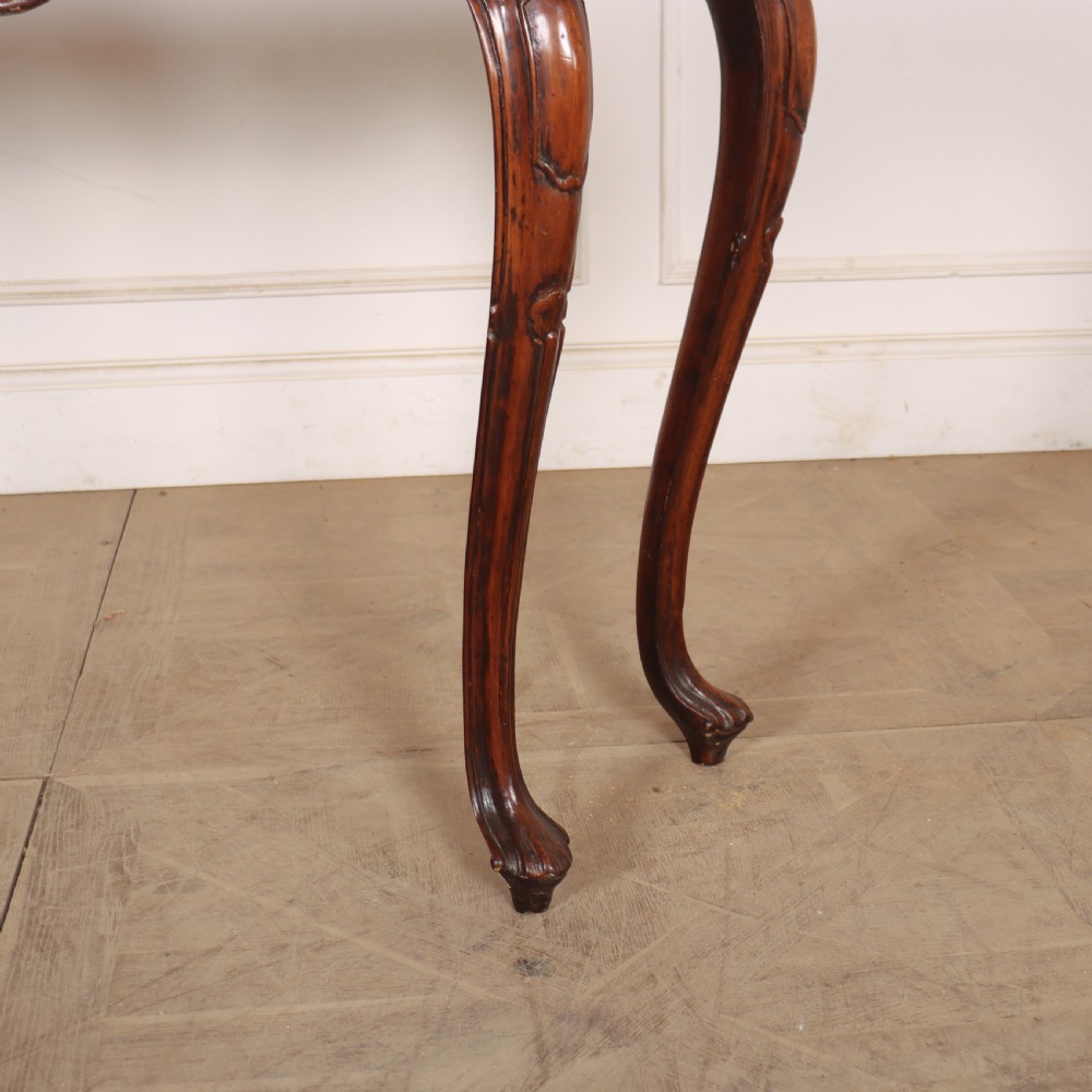 An antique 1920s Italian console table featuring a serpentine front, carved apron with scroll detailing, cabriole legs, and a marble top. View VI