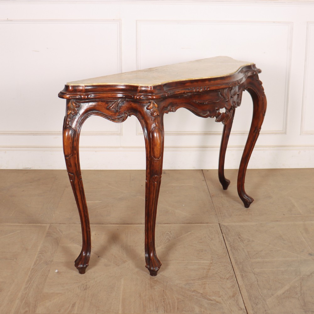 An antique 1920s Italian console table featuring a serpentine front, carved apron with scroll detailing, cabriole legs, and a marble top. View VII