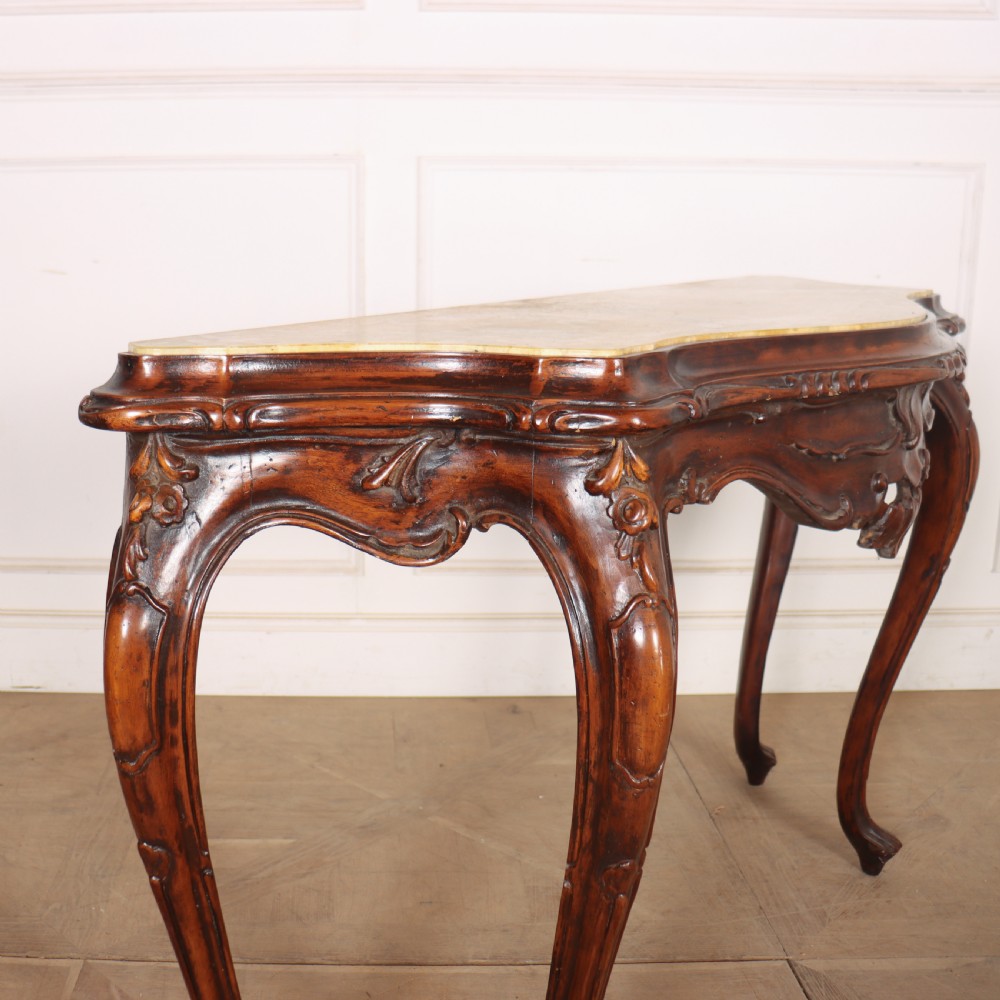 An antique 1920s Italian console table featuring a serpentine front, carved apron with scroll detailing, cabriole legs, and a marble top. View VIII