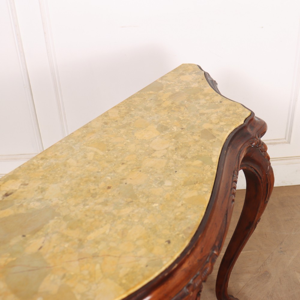 An antique 1920s Italian console table featuring a serpentine front, carved apron with scroll detailing, cabriole legs, and a marble top. View X
