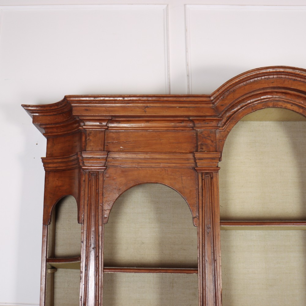 A large 1920s Italian walnut breakfront bookcase with open arched upper shelving and panelled lower cupboard doors. View II