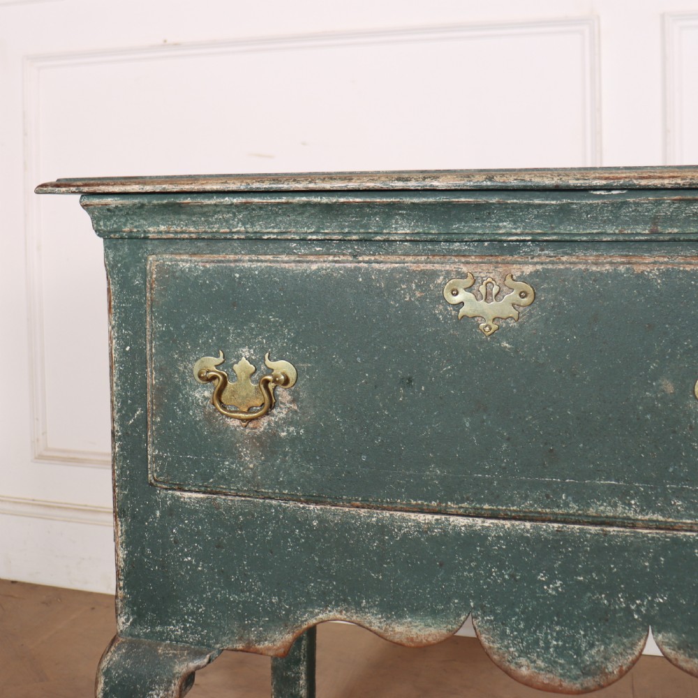 A long antique green painted dresser base featuring three drawers with brass handles, a scalloped apron with pierced fretwork, and cabriole legs. View VII