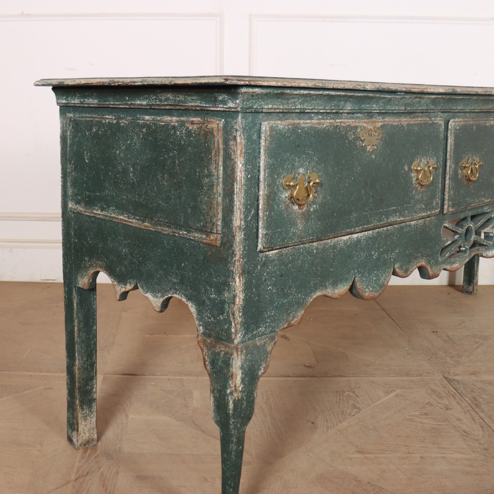 A long antique green painted dresser base featuring three drawers with brass handles, a scalloped apron with pierced fretwork, and cabriole legs. View XI