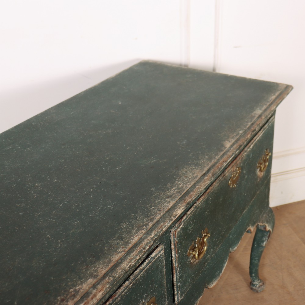 A long antique green painted dresser base featuring three drawers with brass handles, a scalloped apron with pierced fretwork, and cabriole legs. View XV