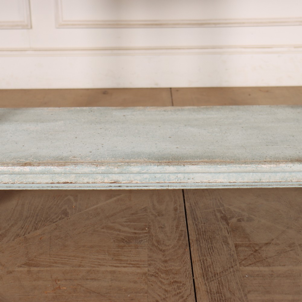 An antique painted wooden washstand featuring bobbin turned legs, a lower shelf, a pale blue distressed finish, and a white marble top with a splashback. View VI