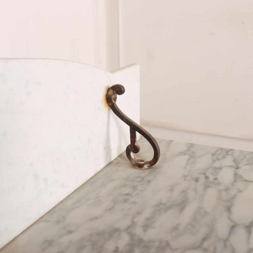 An antique painted wooden washstand featuring bobbin turned legs, a lower shelf, a pale blue distressed finish, and a white marble top with a splashback. View IX