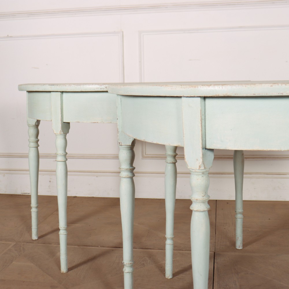 A pair of semi-circular Swedish console tables featuring pale green painted finishes, turned legs, and flat back edges. View III
