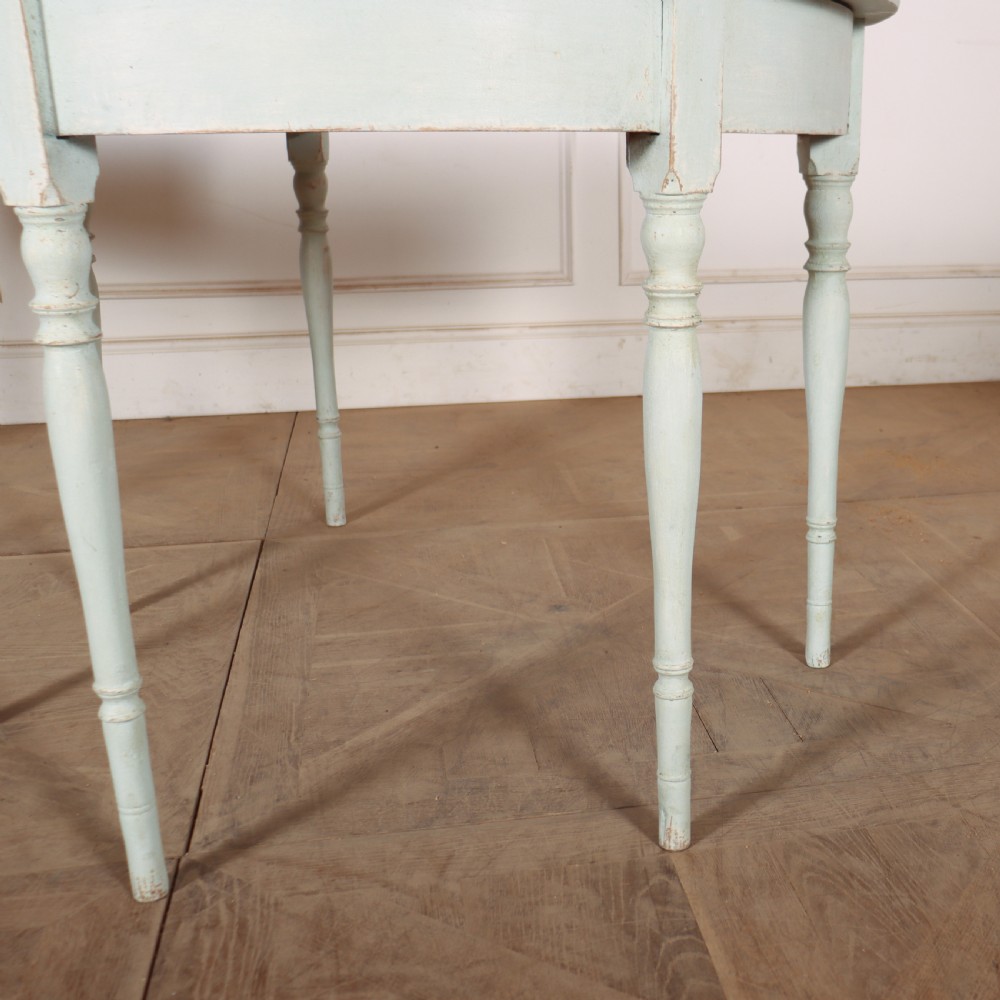 A pair of semi-circular Swedish console tables featuring pale green painted finishes, turned legs, and flat back edges. View VI