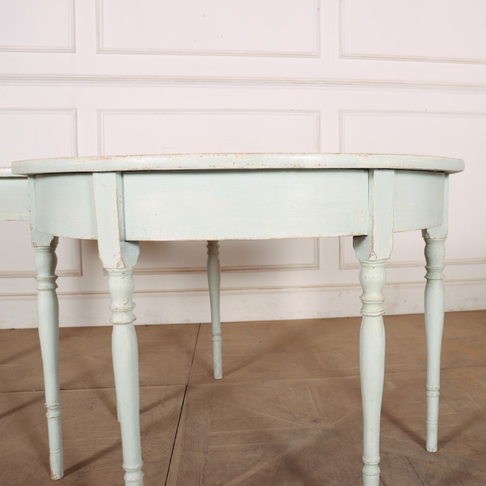 A pair of semi-circular Swedish console tables featuring pale green painted finishes, turned legs, and flat back edges. View VII