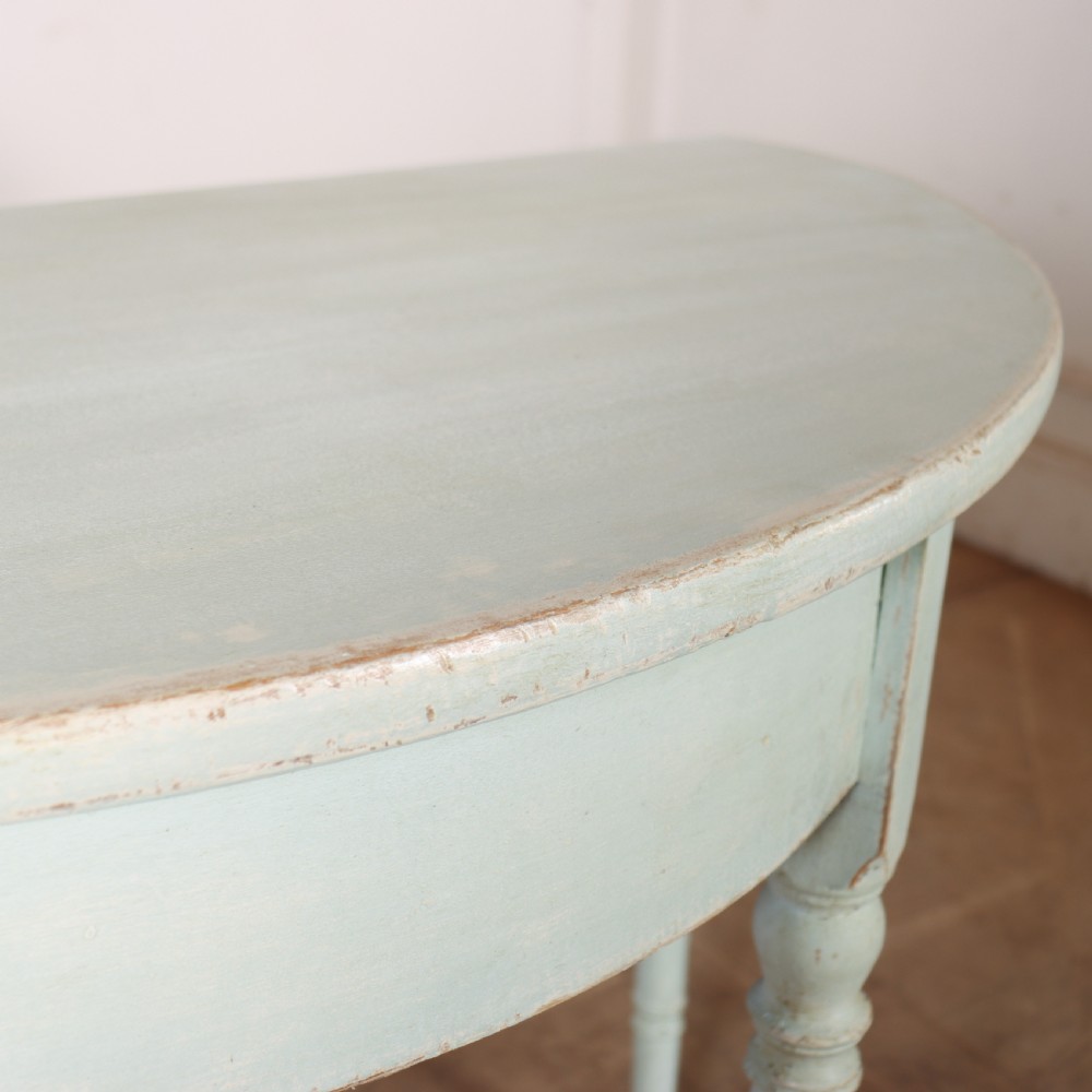 A pair of semi-circular Swedish console tables featuring pale green painted finishes, turned legs, and flat back edges. View VIII