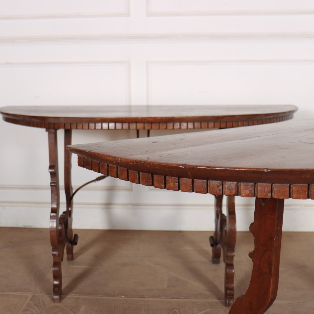 A pair of semi-circular Italian walnut console tables with carved apron detailing, lyre-shaped legs, and curved wrought iron stretchers. View II