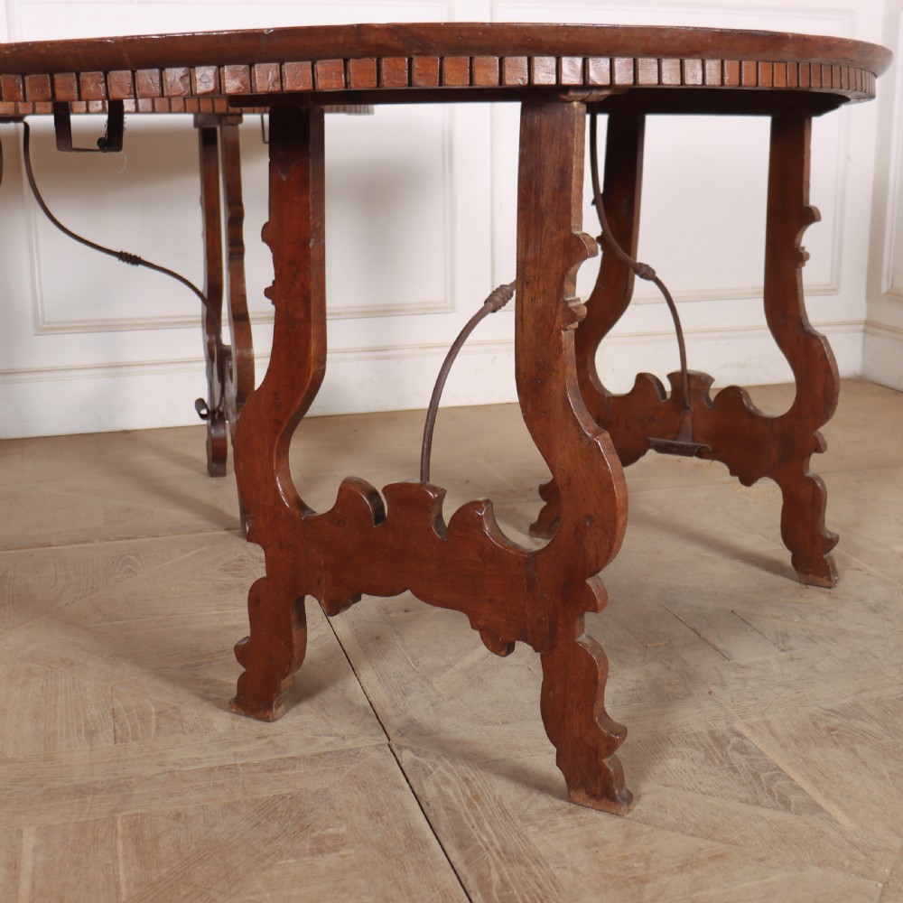 A pair of semi-circular Italian walnut console tables with carved apron detailing, lyre-shaped legs, and curved wrought iron stretchers. View III