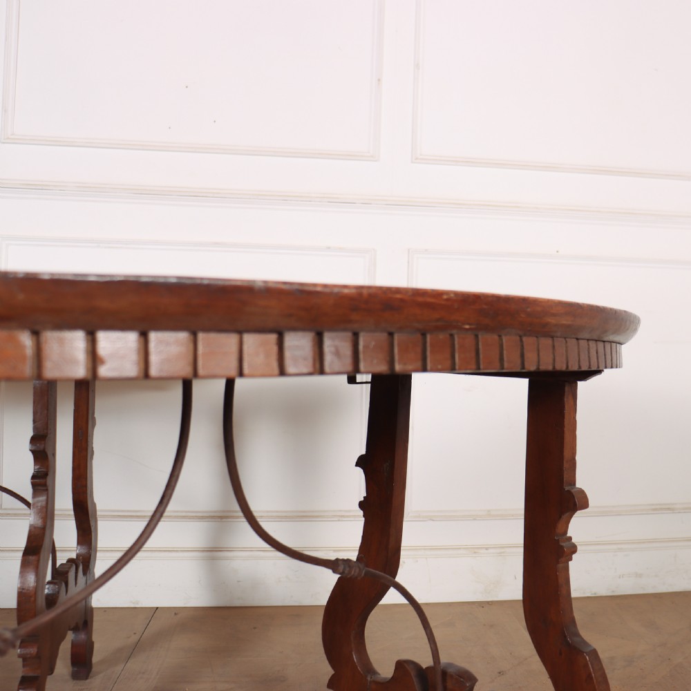A pair of semi-circular Italian walnut console tables with carved apron detailing, lyre-shaped legs, and curved wrought iron stretchers. View IV