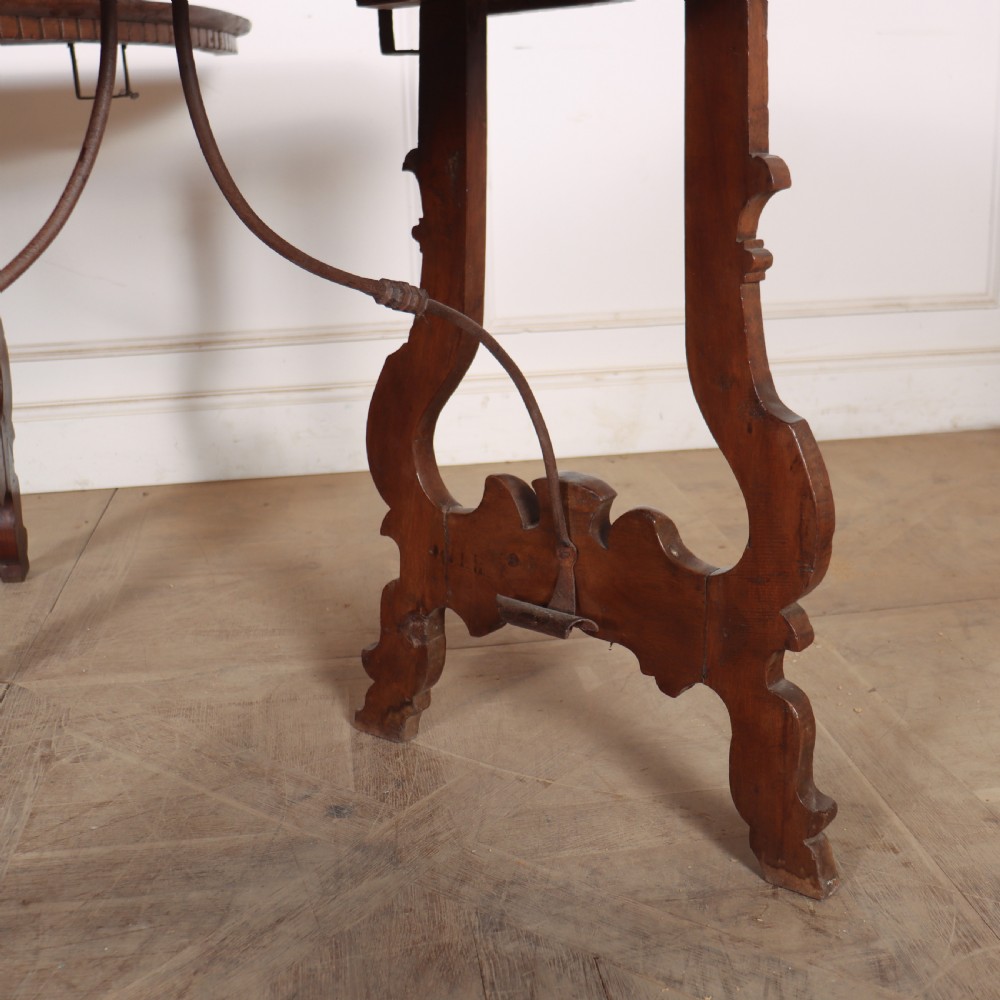 A pair of semi-circular Italian walnut console tables with carved apron detailing, lyre-shaped legs, and curved wrought iron stretchers. View V