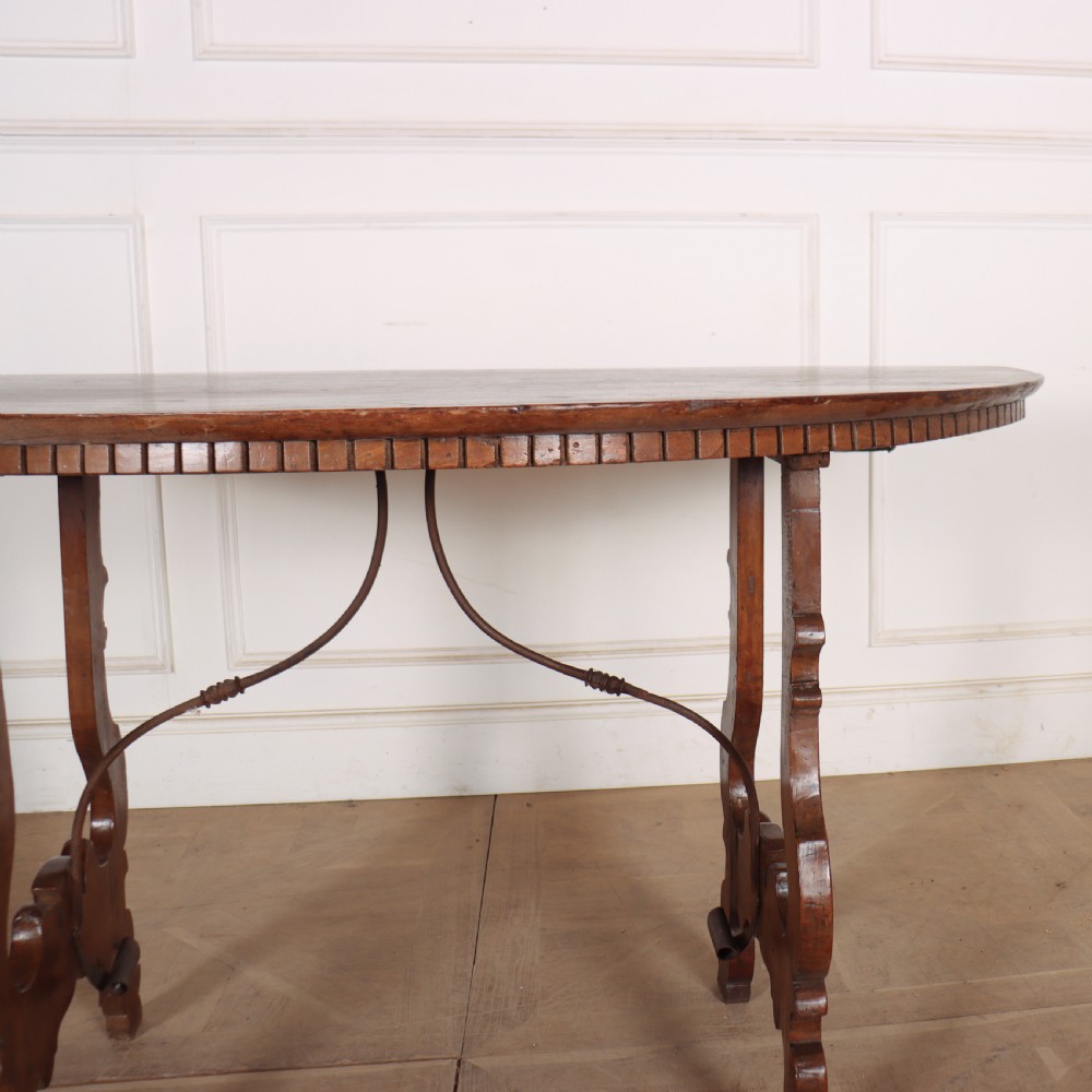 A pair of semi-circular Italian walnut console tables with carved apron detailing, lyre-shaped legs, and curved wrought iron stretchers. View VII