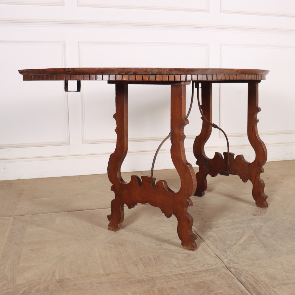 A pair of semi-circular Italian walnut console tables with carved apron detailing, lyre-shaped legs, and curved wrought iron stretchers. View VIII