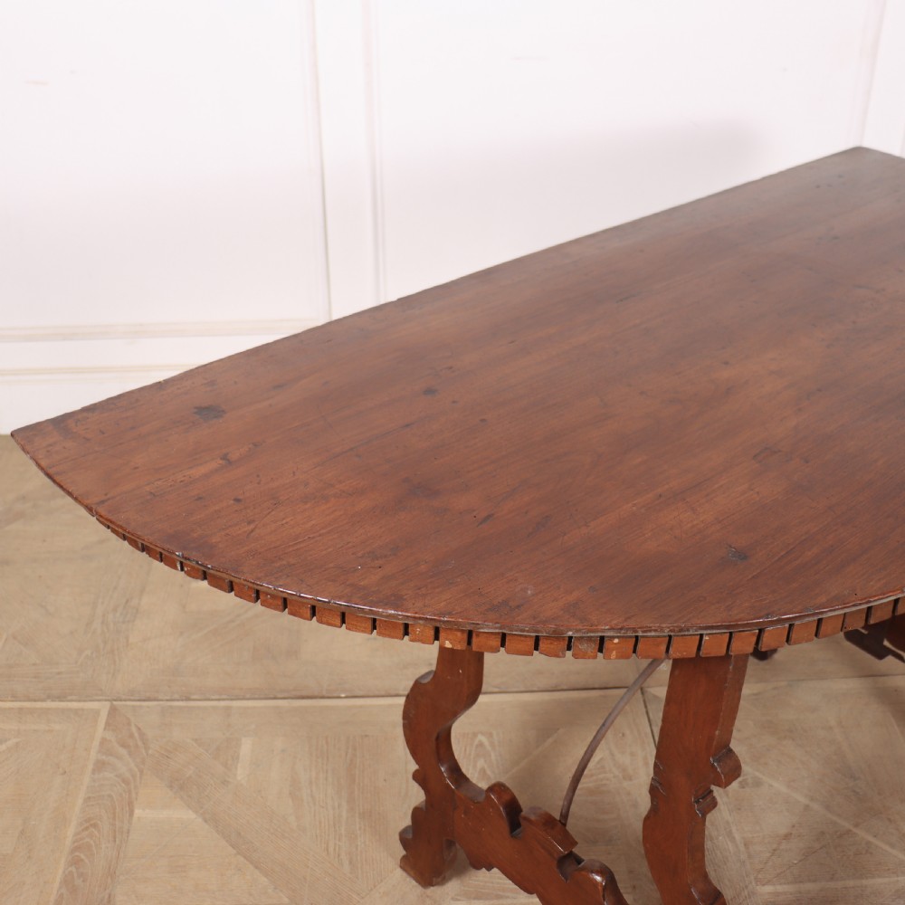 A pair of semi-circular Italian walnut console tables with carved apron detailing, lyre-shaped legs, and curved wrought iron stretchers. View IX