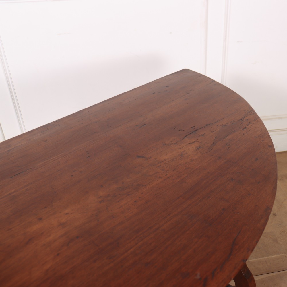 A pair of semi-circular Italian walnut console tables with carved apron detailing, lyre-shaped legs, and curved wrought iron stretchers. View X