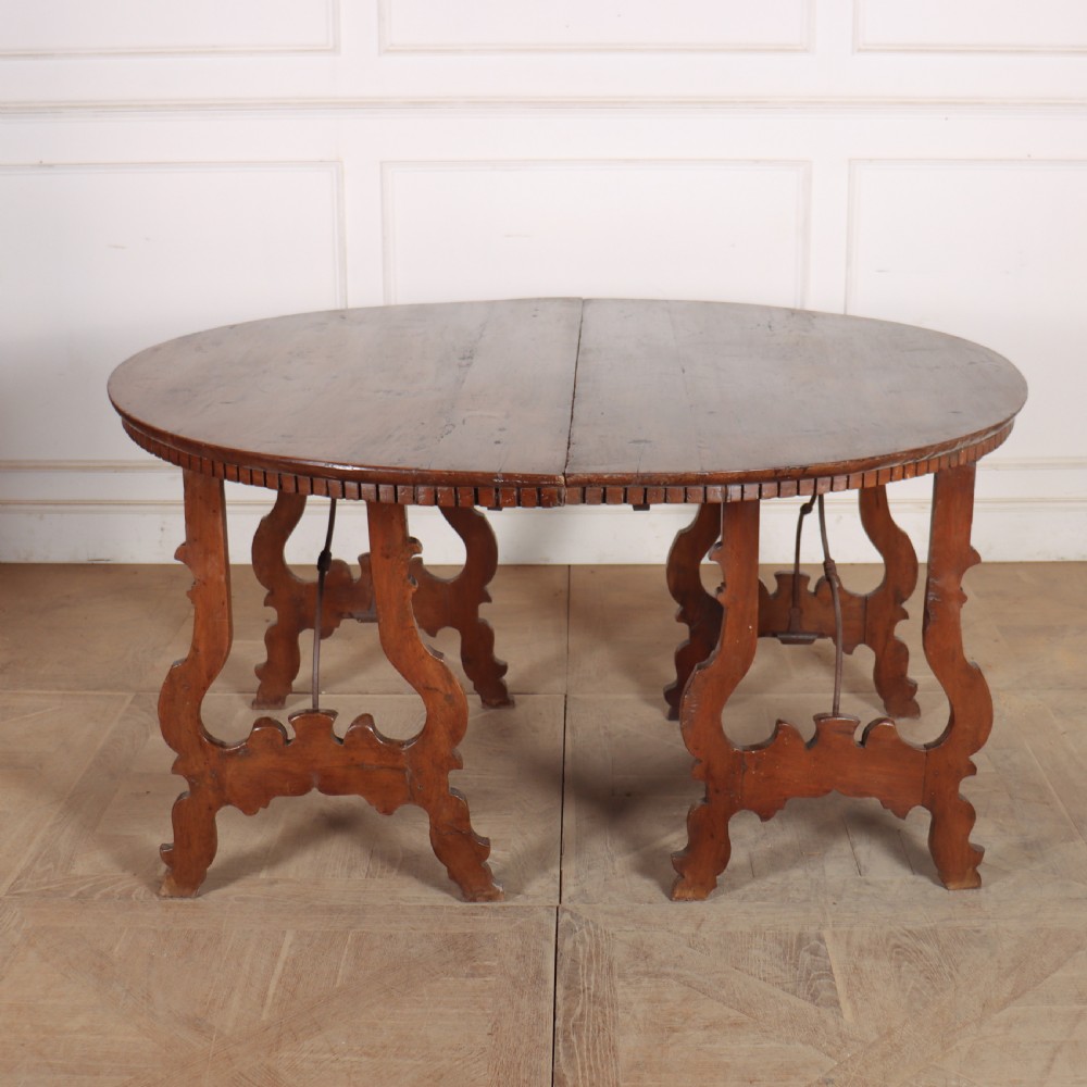 A pair of semi-circular Italian walnut console tables with carved apron detailing, lyre-shaped legs, and curved wrought iron stretchers. View XI