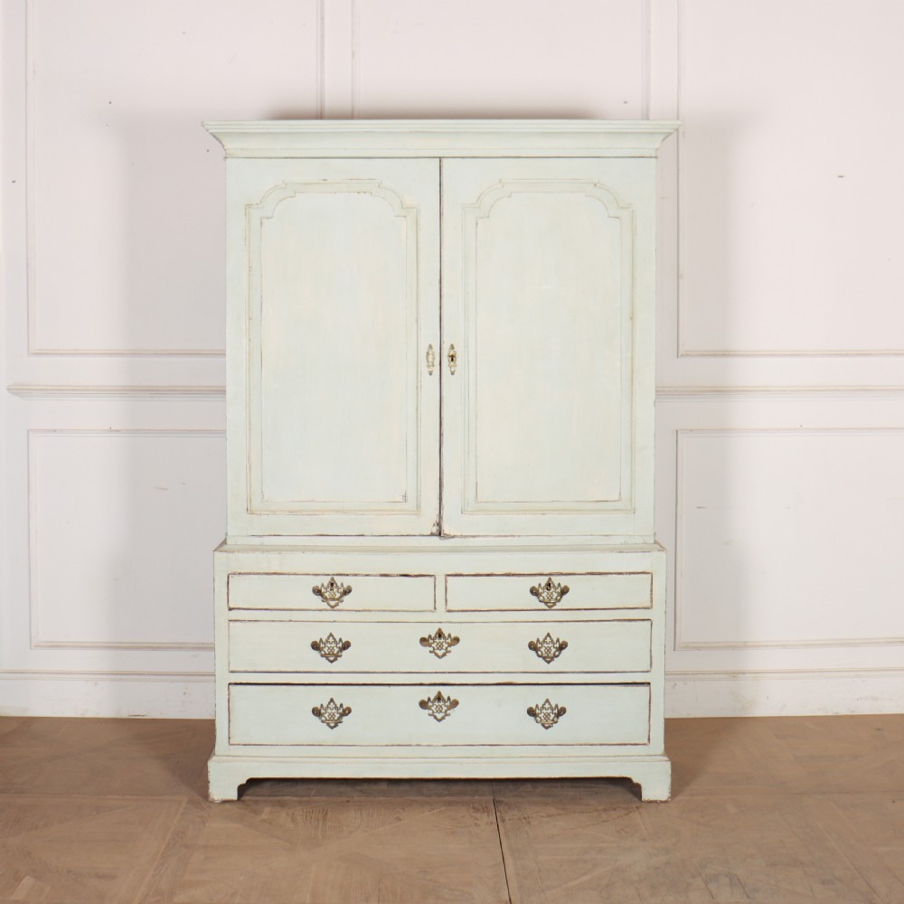 A two-piece pale blue painted timber hanging cupboard featuring panelled doors over a base with drawers and brass handles.