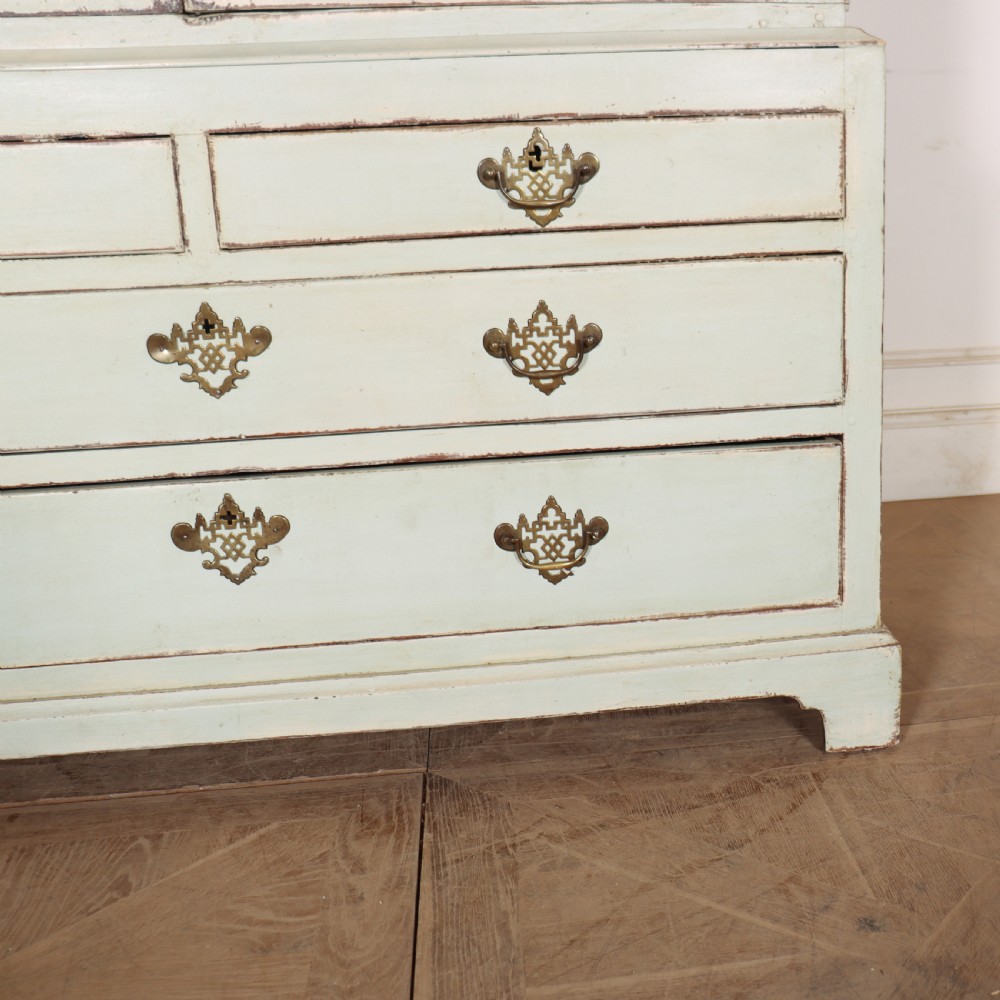 A two-piece pale blue painted timber hanging cupboard featuring panelled doors over a base with drawers and brass handles. View IV