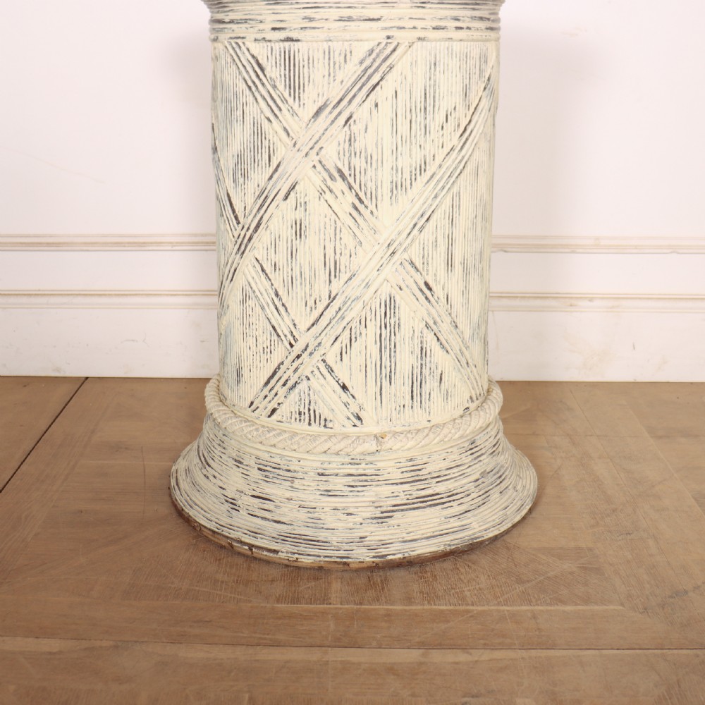 A cylindrical off-white painted wooden sculpture stand featuring carved cross-hatching patterns, a rope-twist lower border, and a distressed finish. View II