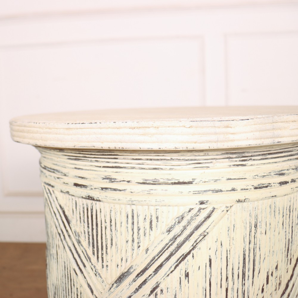 A cylindrical off-white painted wooden sculpture stand featuring carved cross-hatching patterns, a rope-twist lower border, and a distressed finish. View VI