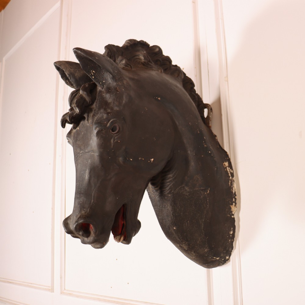A 19th-century dark painted plaster wall-mounted bust of a horse head in profile showing fine carved details. View II