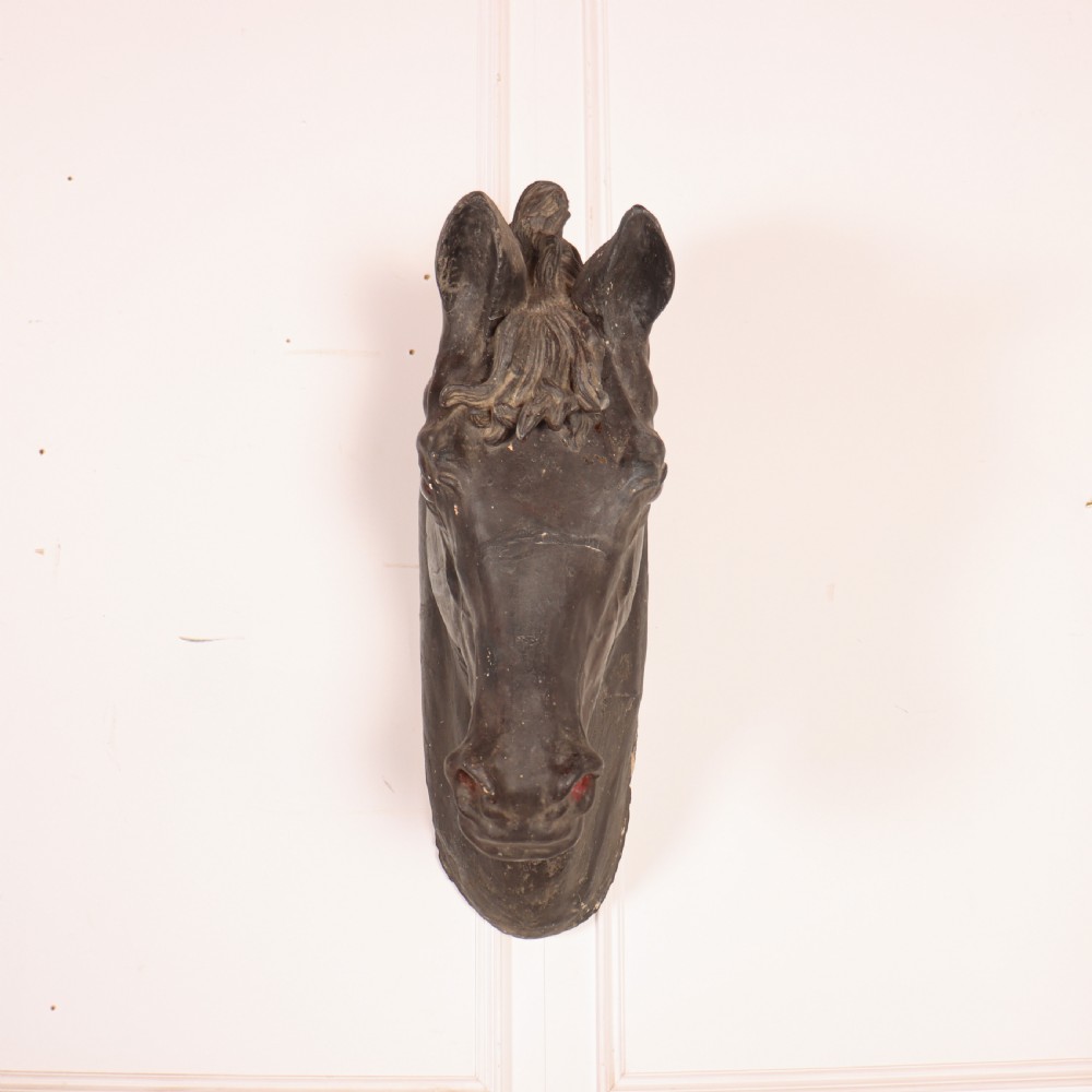 A 19th-century dark painted plaster wall-mounted bust of a horse head in profile showing fine carved details. View III