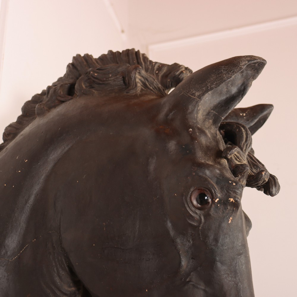 A 19th-century dark painted plaster wall-mounted bust of a horse head in profile showing fine carved details. View IV