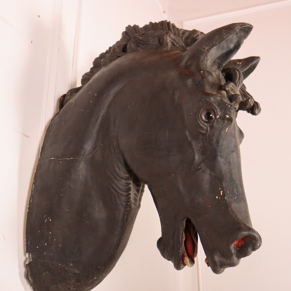 A 19th-century dark painted plaster wall-mounted bust of a horse head in profile showing fine carved details. View V