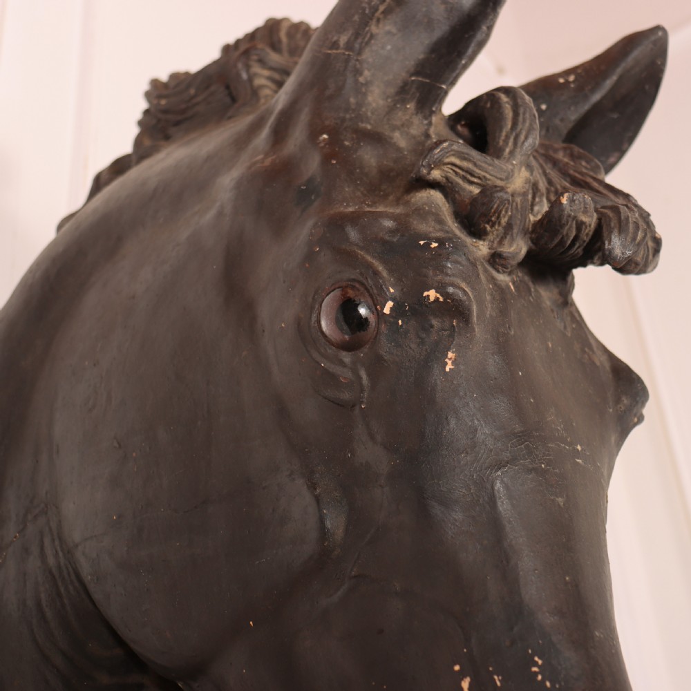 A 19th-century dark painted plaster wall-mounted bust of a horse head in profile showing fine carved details. View VI
