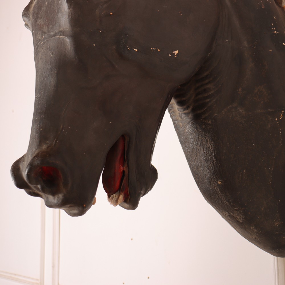 A 19th-century dark painted plaster wall-mounted bust of a horse head in profile showing fine carved details. View VIII