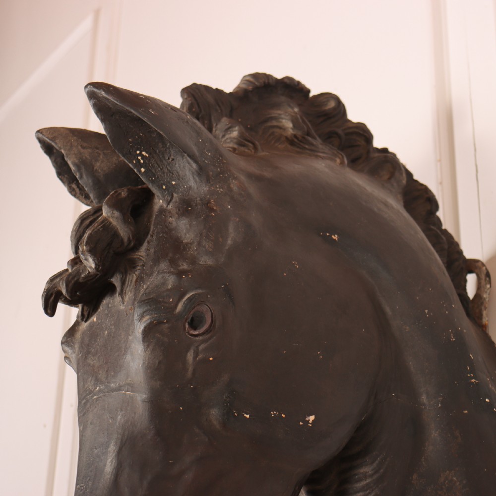 A 19th-century dark painted plaster wall-mounted bust of a horse head in profile showing fine carved details. View IX