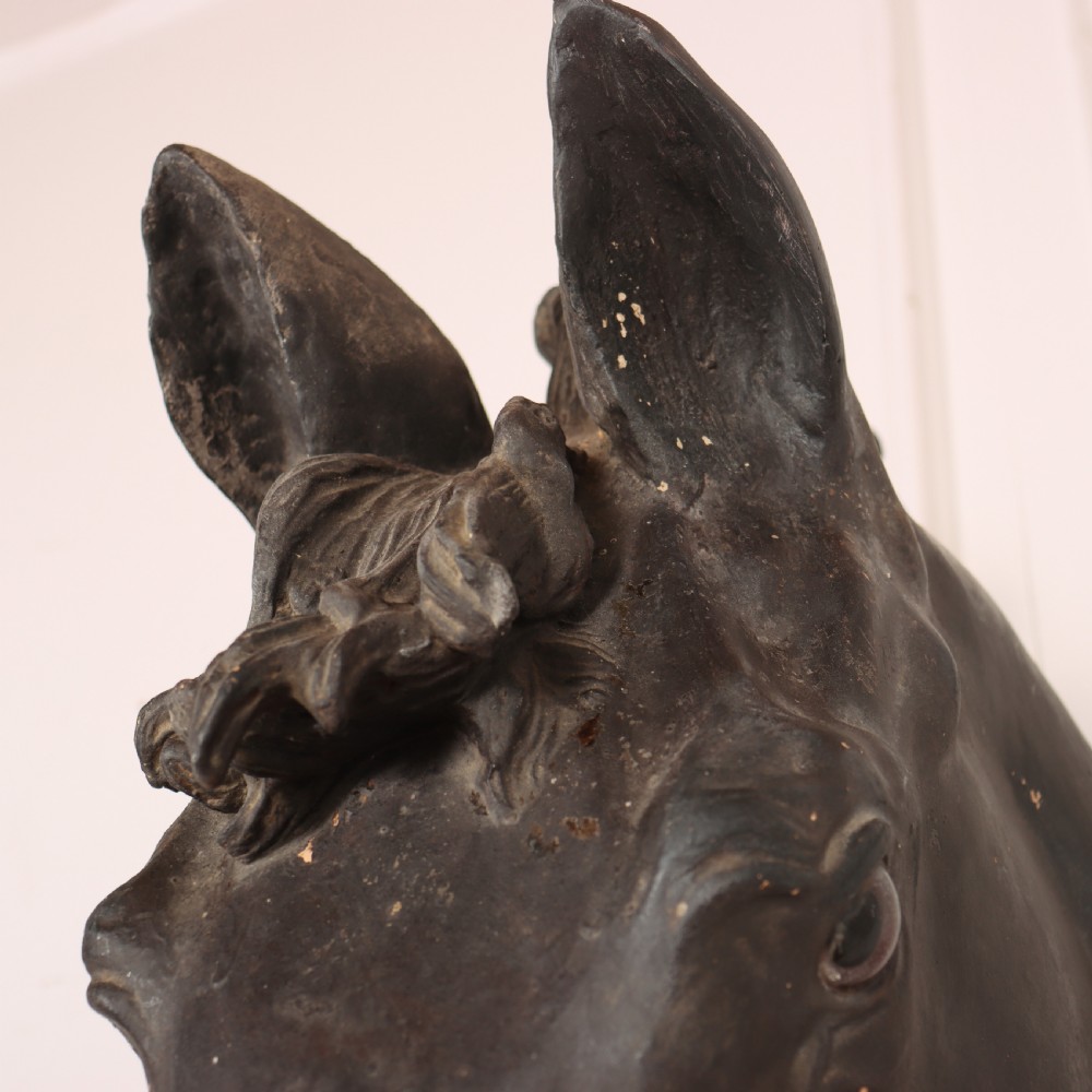 A 19th-century dark painted plaster wall-mounted bust of a horse head in profile showing fine carved details. View X