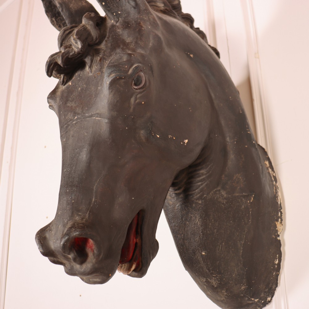 A 19th-century dark painted plaster wall-mounted bust of a horse head in profile showing fine carved details. View XIV