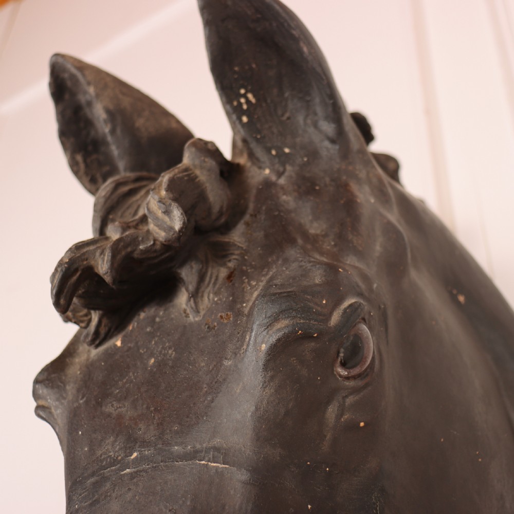 A 19th-century dark painted plaster wall-mounted bust of a horse head in profile showing fine carved details. View XV