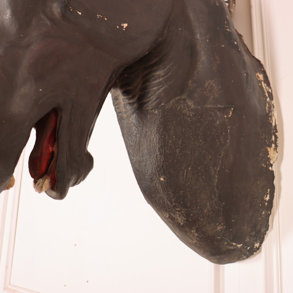 A 19th-century dark painted plaster wall-mounted bust of a horse head in profile showing fine carved details. View XVI