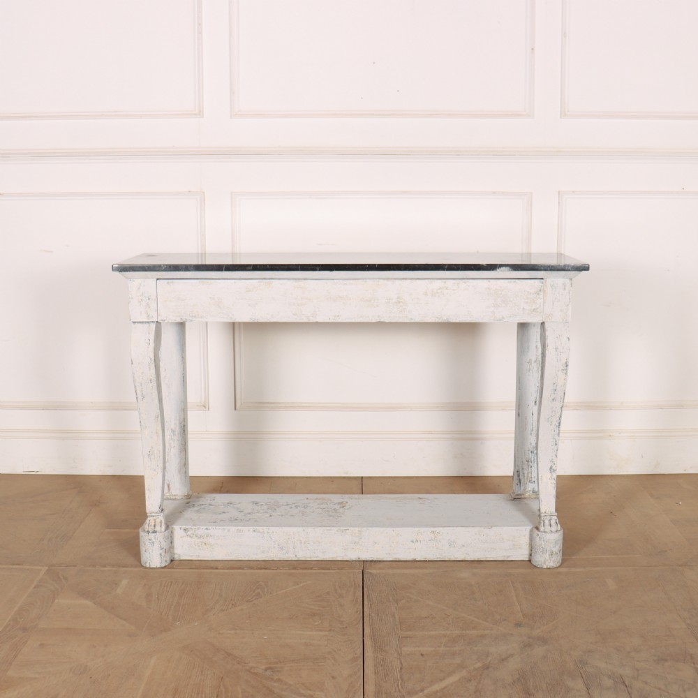 A French provincial painted wooden console table featuring a dark marble top and a lower display tier.