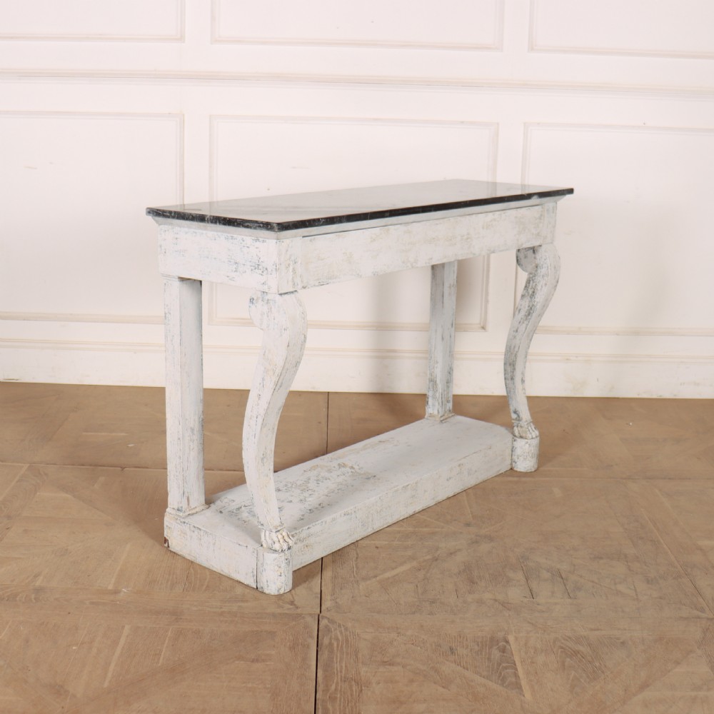 A French provincial painted wooden console table featuring a dark marble top and a lower display tier. View II
