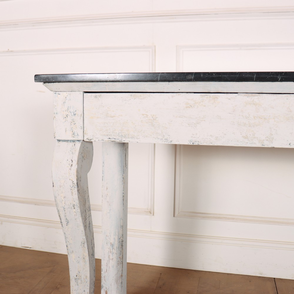 A French provincial painted wooden console table featuring a dark marble top and a lower display tier. View III
