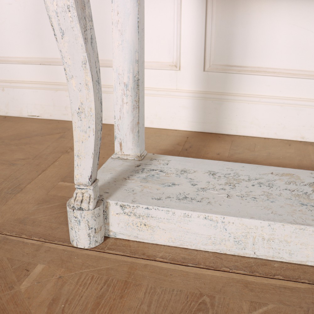 A French provincial painted wooden console table featuring a dark marble top and a lower display tier. View IV