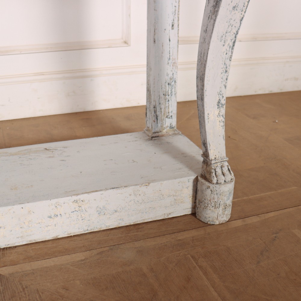 A French provincial painted wooden console table featuring a dark marble top and a lower display tier. View V