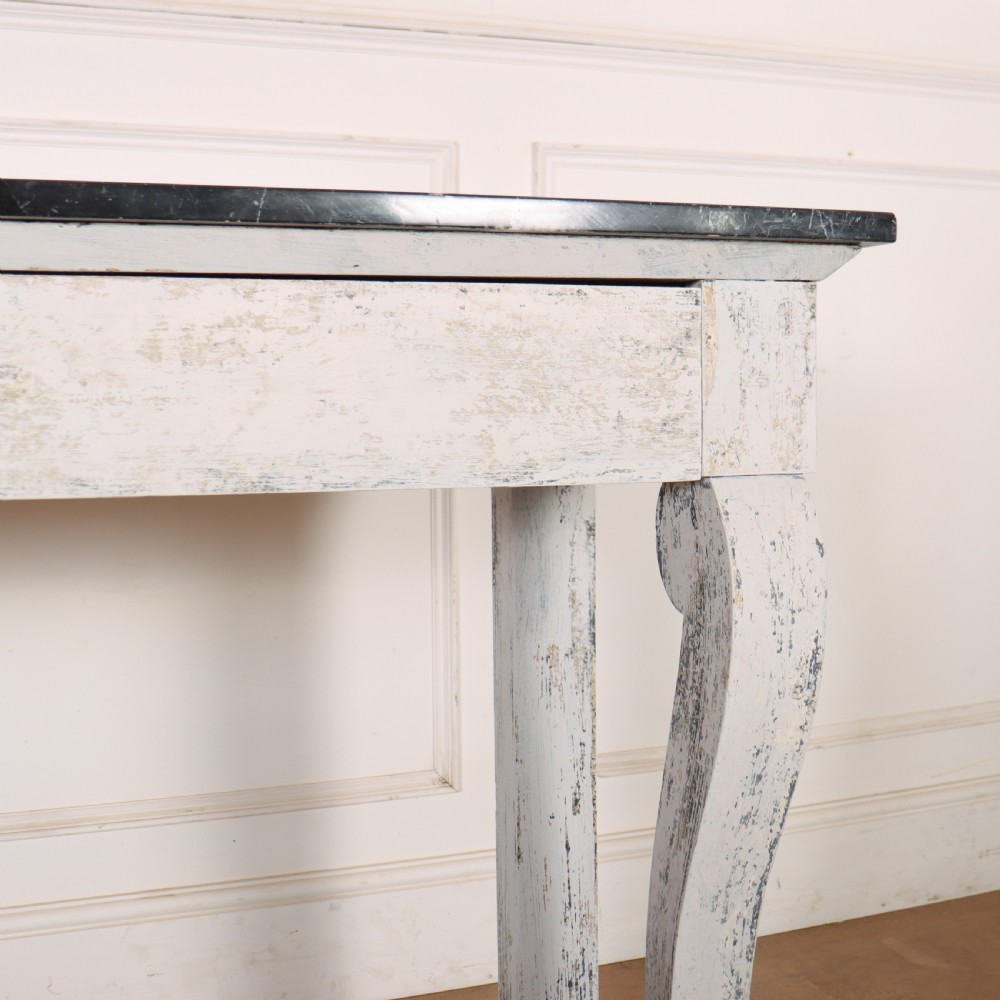 A French provincial painted wooden console table featuring a dark marble top and a lower display tier. View VI